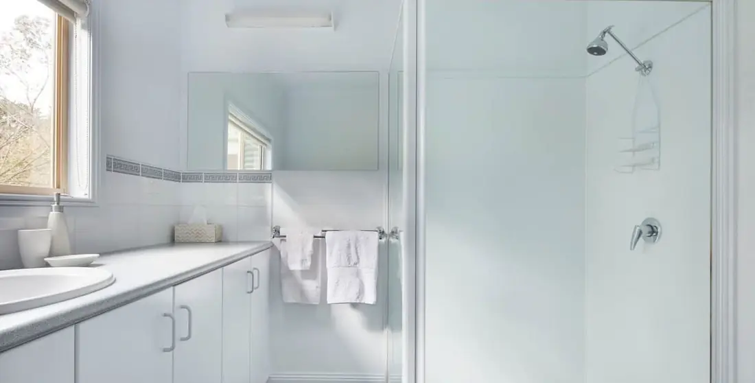 Bright white bathroom with walk-in shower
