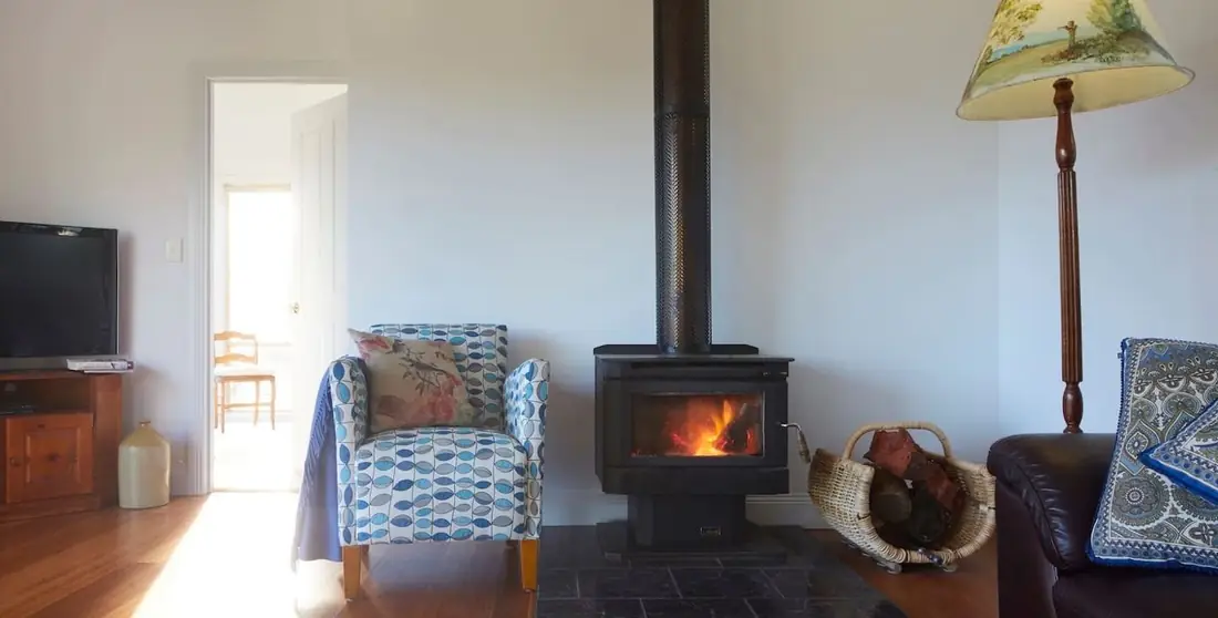 Wood fire with armchairs beside it
